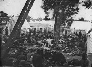 Casualties lie in no clear system outside a field hospital